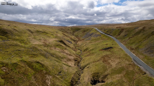 Aerial view of the road in the mountains during the cloudy day