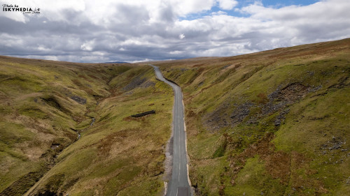 Aerial view of the road in the mountains during the cloudy day